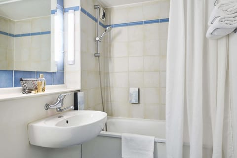 Bathtub, eco-friendly toiletries, hair dryer, towels