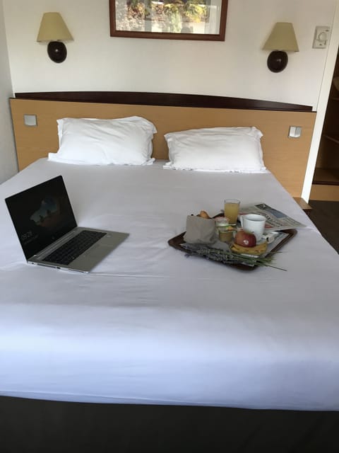 Premium bedding, desk, laptop workspace, blackout drapes