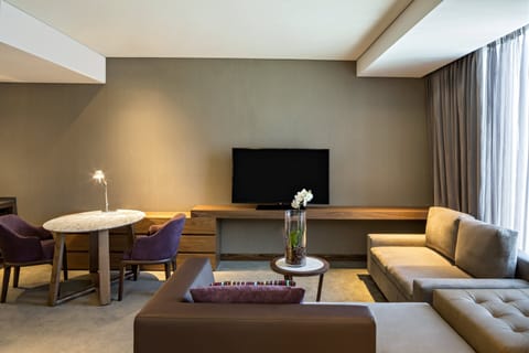 Junior Suite | Living area | 55-inch flat-screen TV with cable channels, TV