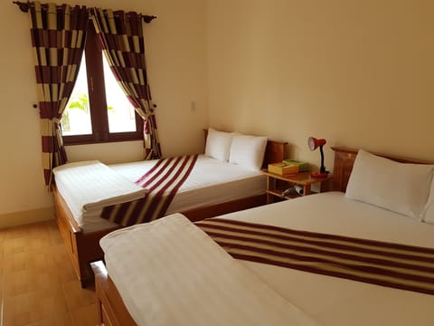 Deluxe Quadruple Room, 2 Queen Beds, Non Smoking, Garden View | Minibar, in-room safe, individually furnished, free WiFi