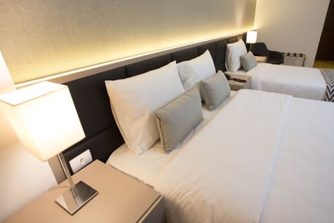 Deluxe Triple Room, Balcony | Minibar, in-room safe, desk, blackout drapes