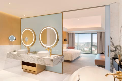 Club Suite, 1 King Bed, City View | Bathroom | Separate tub and shower, rainfall showerhead, designer toiletries