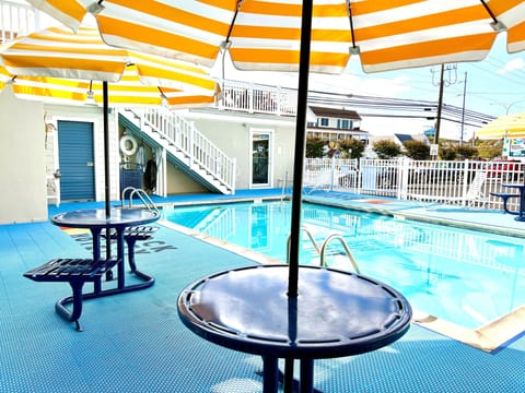 Seasonal outdoor pool, open 9:00 AM to 9:00 PM, pool umbrellas