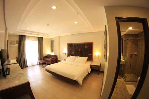 Deluxe Room, 1 Bedroom, Pool View | In-room safe, desk, blackout drapes, soundproofing