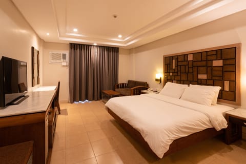 Deluxe Room, 1 Bedroom, Pool View | In-room safe, desk, blackout drapes, soundproofing