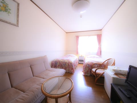 Deluxe Twin Room, 2 Bedrooms, Refrigerator | Living area | Flat-screen TV