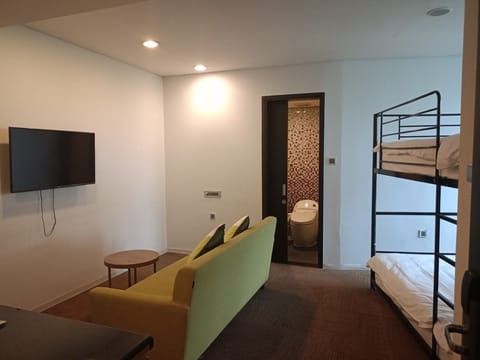 Shared Dormitory, 4 Bedrooms | Living area | Flat-screen TV