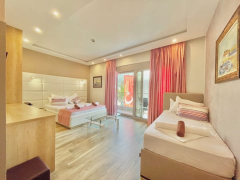 Standard Triple Room, Balcony | Minibar, in-room safe, individually decorated, individually furnished