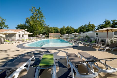 Seasonal outdoor pool, open 10:00 AM to 9:30 PM, pool umbrellas