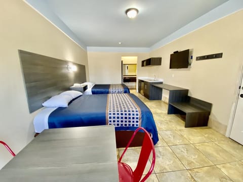 Suite, 2 Queen Beds, Kitchenette, Ground Floor | In-room safe, desk, laptop workspace, blackout drapes