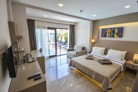 Deluxe Room, Pool View | In-room safe, desk, laptop workspace, iron/ironing board