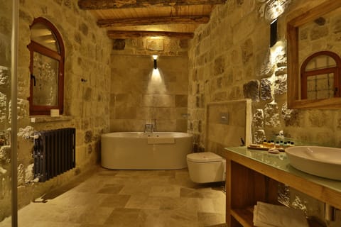 Exclusive Cave Suite | Bathroom | Designer toiletries, hair dryer, slippers, towels