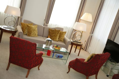 Luxury Suite | Living area | 20-inch flat-screen TV with satellite channels, TV, tablet