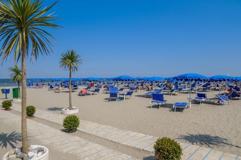 On the beach, white sand, sun loungers, beach umbrellas