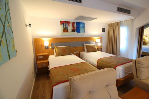 Deluxe Quadruple Room, 1 Bedroom | Free minibar, in-room safe, desk, laptop workspace