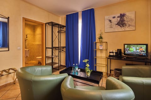 Junior Suite | Living area | 22-inch flat-screen TV with satellite channels, TV