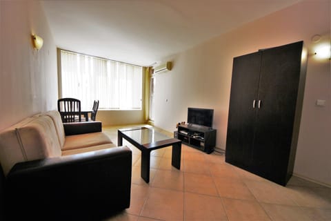 Comfort Apartment, Pool View | Living area | 30-cm TV with cable channels