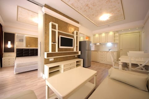 Deluxe Apartment, Sea View | Living area | 30-cm flat-screen TV with cable channels, TV