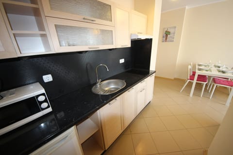 Family Apartment, Balcony | Private kitchenette | Fridge, stovetop, electric kettle, cookware/dishes/utensils