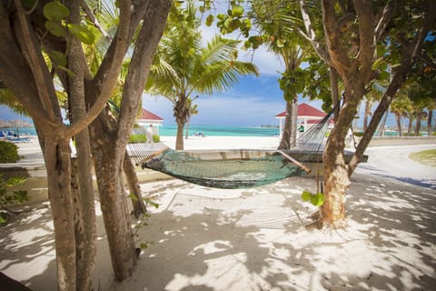 On the beach, white sand, beach cabanas, sun loungers