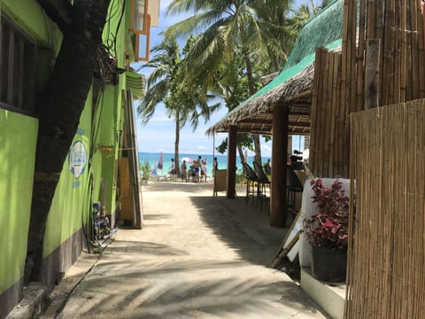 Beach nearby, white sand, beach towels, motor boating