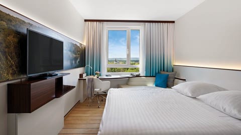 Hypo-allergenic bedding, desk, laptop workspace, blackout drapes