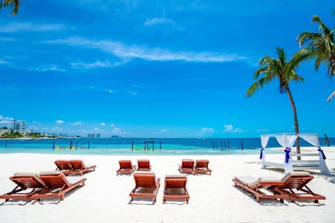 On the beach, white sand, sun loungers, beach towels