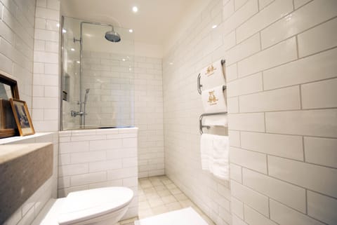 Deluxe Room | Bathroom | Designer toiletries, hair dryer, slippers, towels