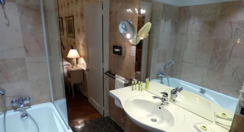 Combined shower/tub, designer toiletries, hair dryer, bathrobes