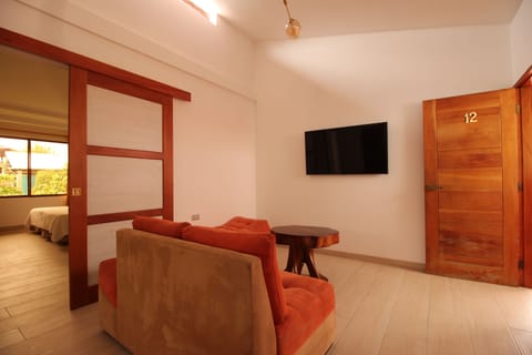 Family Suite, 2 Bedrooms, Garden View | Living area | 32-inch flat-screen TV with cable channels, TV