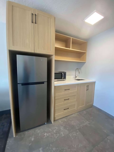 Suite, 1 King Bed, Non Smoking, Kitchenette (Dining Table;Walk-in Shower) | Private kitchenette | Fridge, microwave, coffee/tea maker