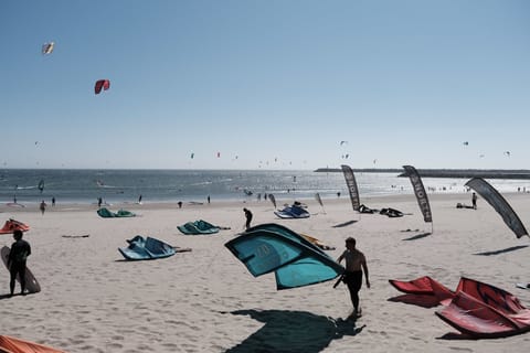 On the beach, windsurfing