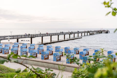 Beach nearby, white sand, beach towels, surfing