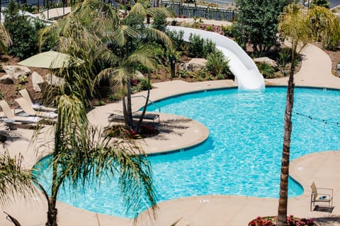 Outdoor pool, open 7:00 AM to 10:00 PM, pool umbrellas, sun loungers