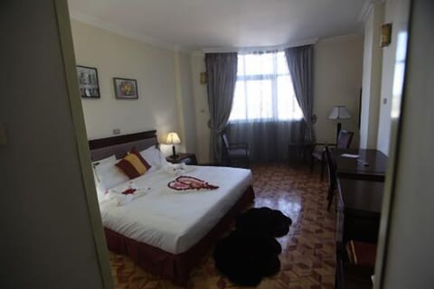 Deluxe Double or Twin Room, City View | Minibar, in-room safe, desk, iron/ironing board