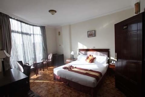 Deluxe Double or Twin Room, City View | Minibar, in-room safe, desk, iron/ironing board