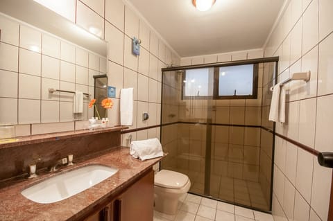 Deluxe Room, Multiple Beds | Bathroom | Shower, rainfall showerhead, towels, soap