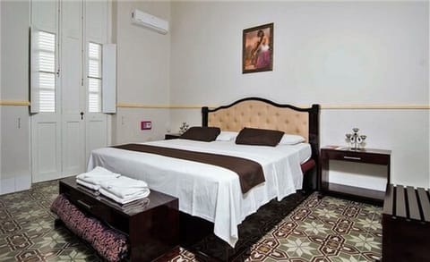 Superior Room | Minibar, in-room safe, iron/ironing board, bed sheets