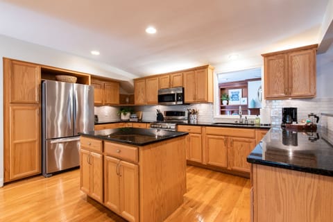 Upscale appliances with dual ovens, refrigerator with water in the door, microwave, dishwasher, and Keurig Duo. Includes all dishes and glassware with seating for 6.