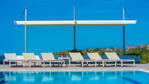 The pool area with a large pergola. The swimming pool is heated on demand.