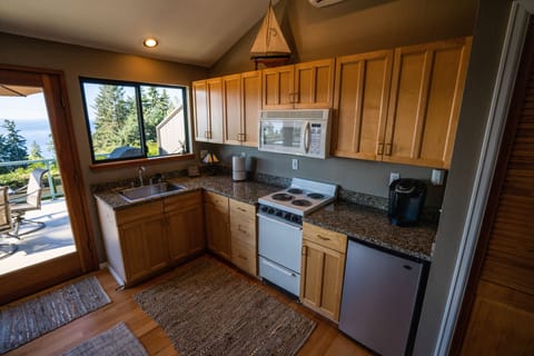 The kitchen is fully stocked with cooking utensils, pots, pans, etc.