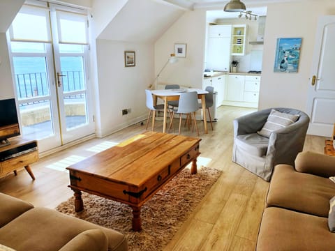 Living and dining area open plan to kitchen with balcony.