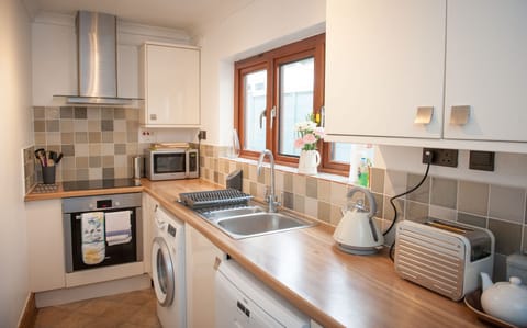 Kitchen is well equipped with electric oven, microwave, dishwasher and washing machine.