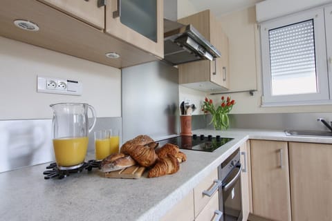 Fully equipped kitchen with access to courtyard.