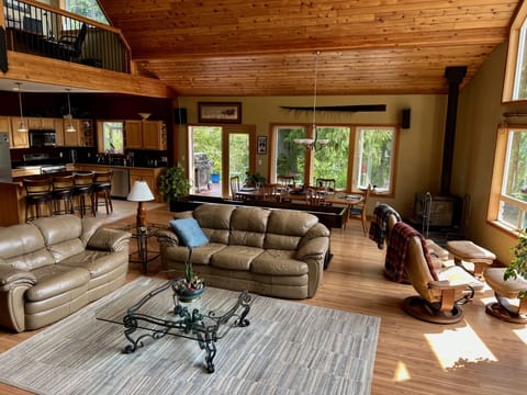 Great room features local art with lots of natural light through large windows