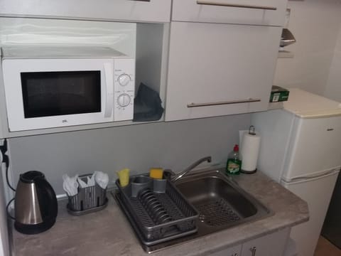 Full-size fridge, microwave, cookware/dishes/utensils