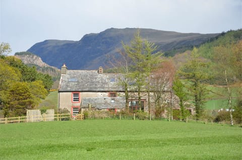 Hallflat Farm with Whin Rigg backdrop, farmhouse on left.
