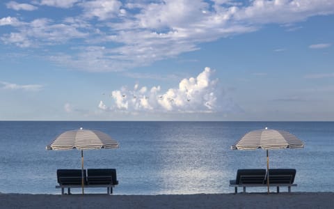 Private beach, white sand, sun loungers, beach umbrellas