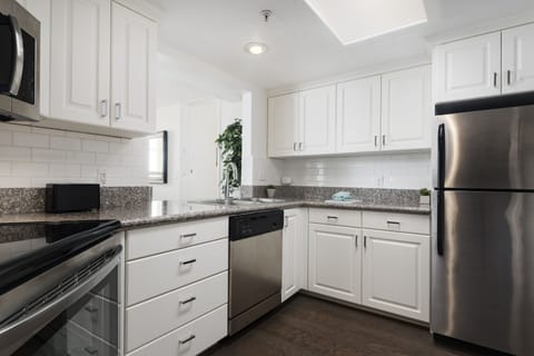 Deluxe Condo, 1 Bedroom | Private kitchen | Microwave, stovetop, dishwasher, coffee/tea maker