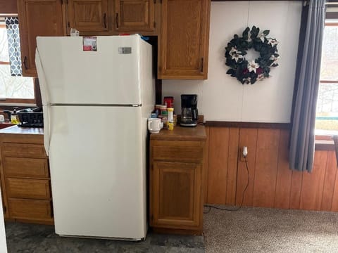 Full-sized fridge with freezer and ice maker.